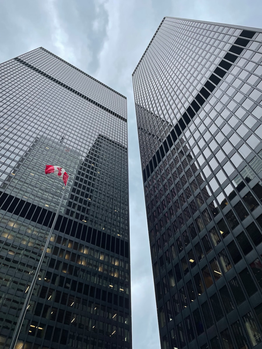 two very tall buildings with a canadian flag on them